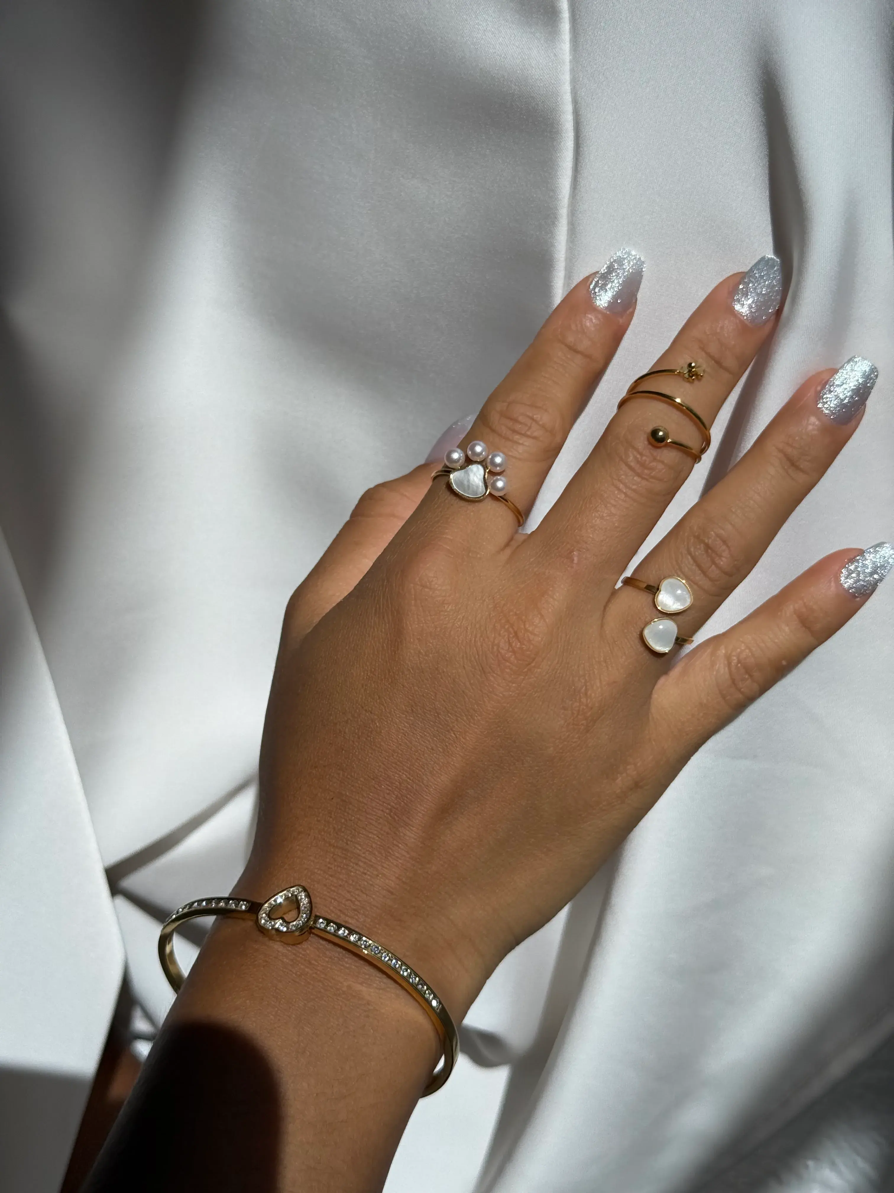 Mano con anillos y pulsera de oro